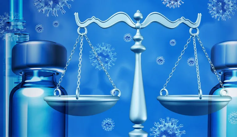 a scale of justice and a bottle of essential oil