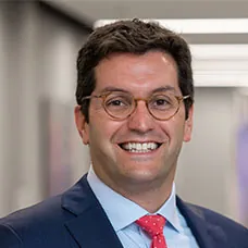 a man wearing glasses and a suit