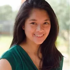 a woman with dark hair wearing a green shirt