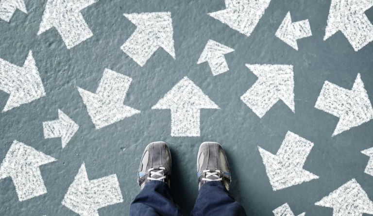 a person standing in front of arrows