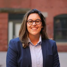 a woman wearing glasses smiling