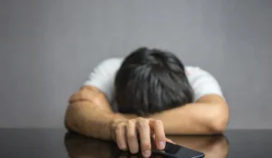 a man with his head on a phone