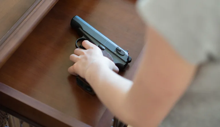 a hand holding a gun