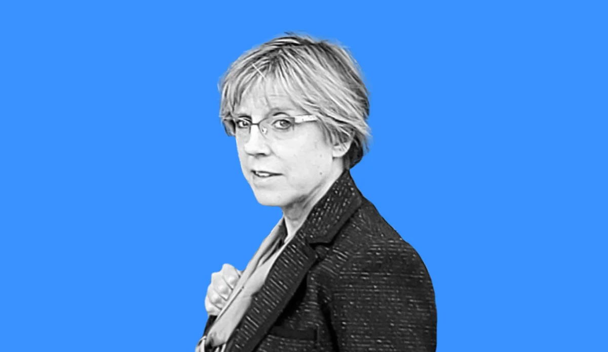 a woman with short hair wearing glasses