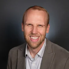 a man in a suit smiling