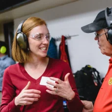 a woman wearing headphones and a man wearing a black hat