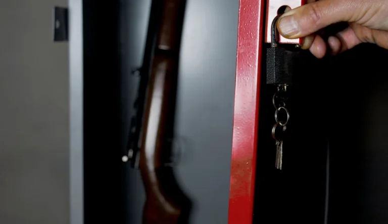 a hand holding a key and a gun