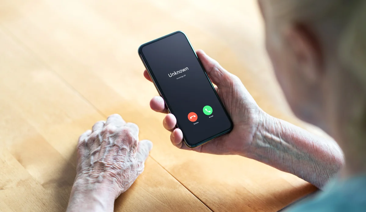 elderly woman receiving a call from a cyber scammer