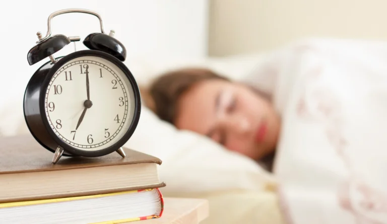 teenager asleep with alarm going off before school