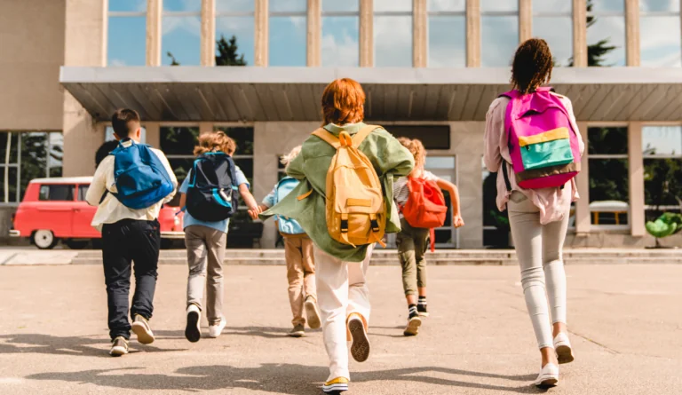 Group of young children walking into school