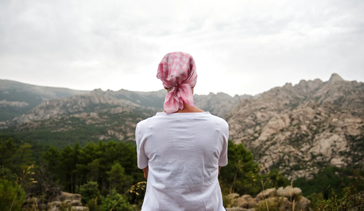 Woman with cancer sitting in a natural space