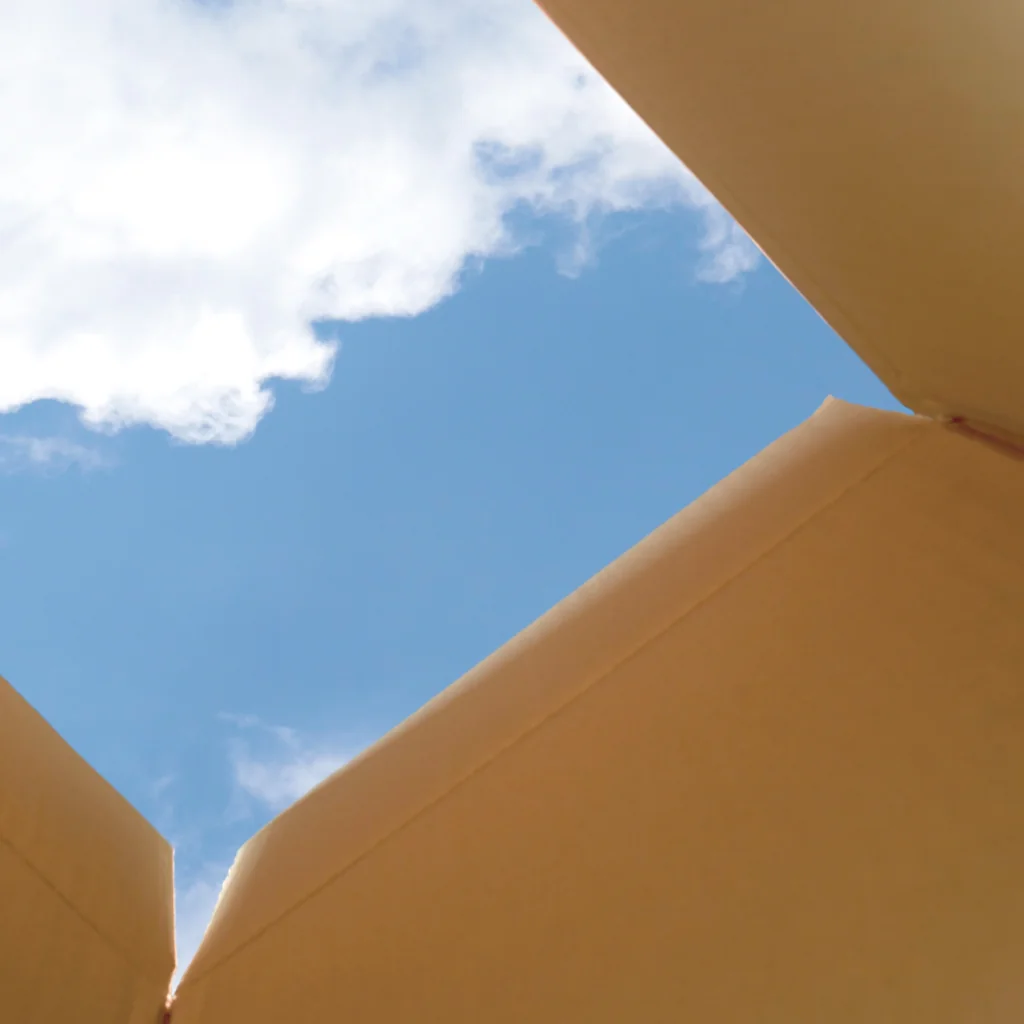 a blue sky and clouds above a box