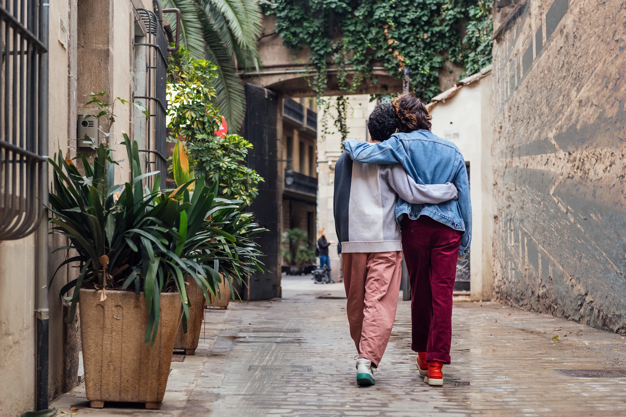 two people hugging on a street