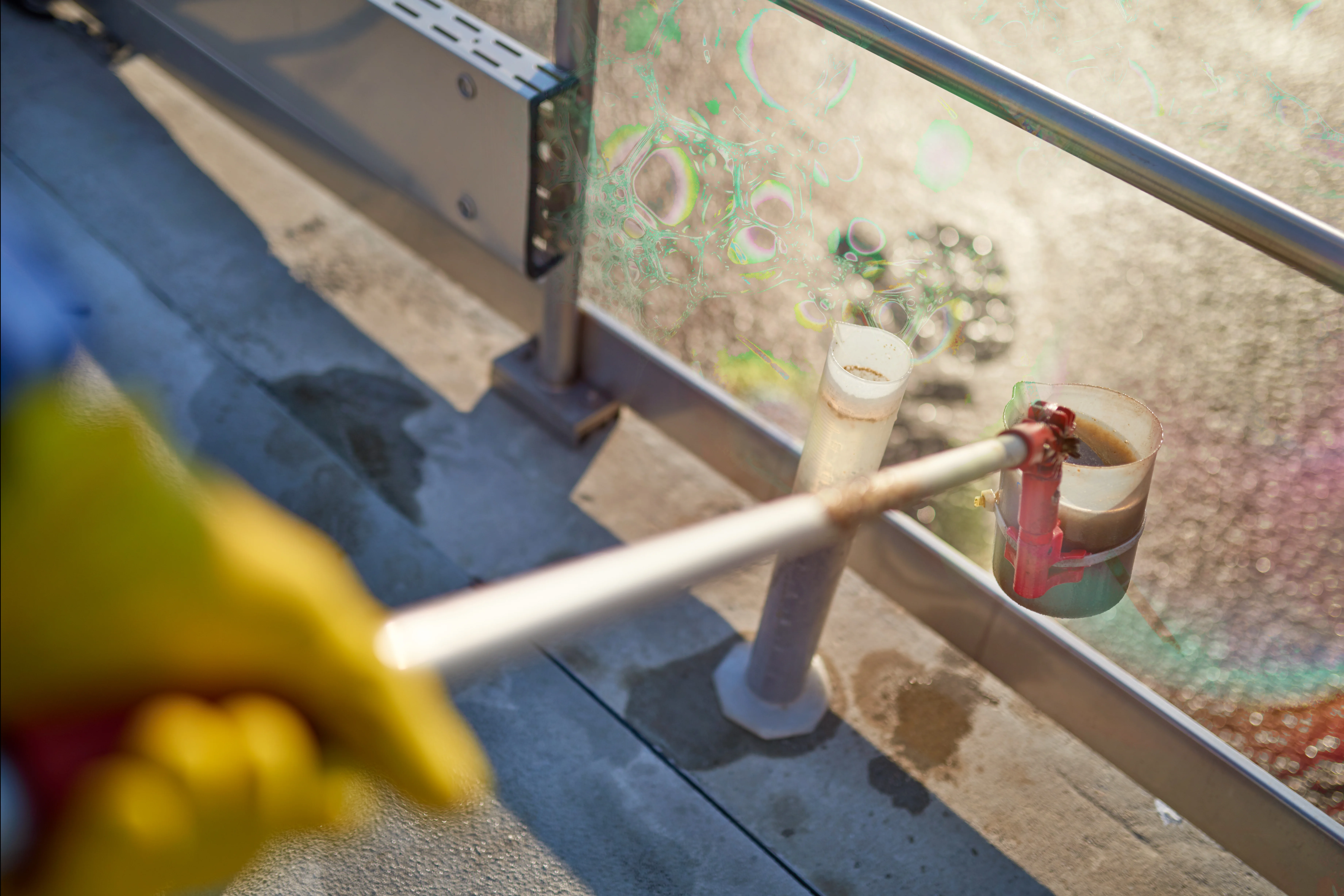 a person using a device to clean the glass