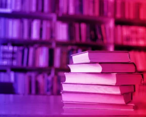 stack of books with a red and blue gradient filter. education concept