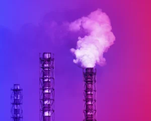 factory stacks with smoke with a red and blue gradient filter. climate concept