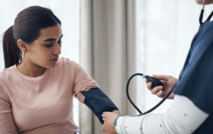 Doctor doing routine care, such as checking a patient's blood pressure