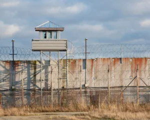 Prison wall and guard lookout tower; recidivism concept