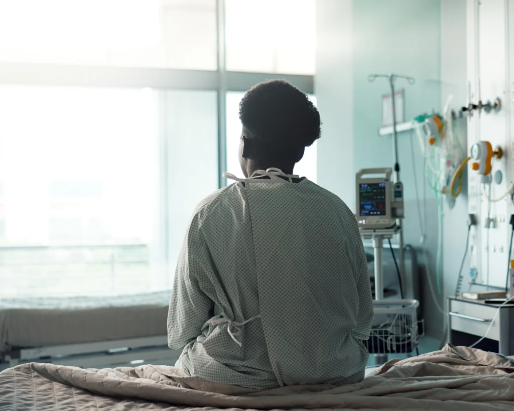 Patient, hospital and sitting on bed with sad, depression and worry for misdiagnosis