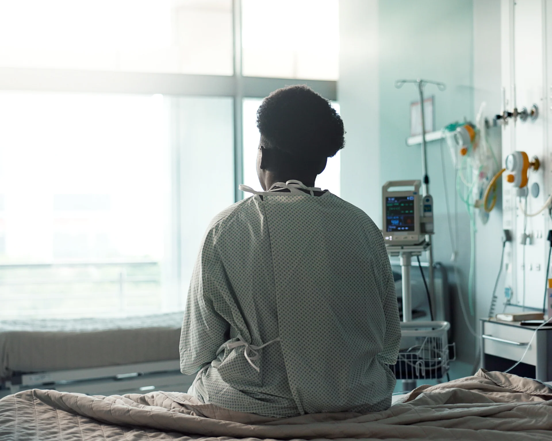 Patient, hospital and sitting on bed with sad, depression and worry for misdiagnosis