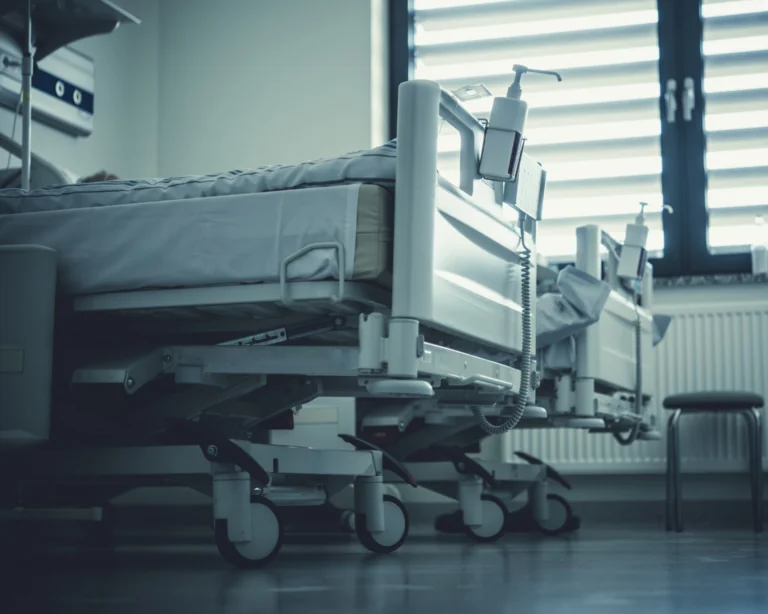 Hospital beds in hospital room. Medical care and surgery access concept