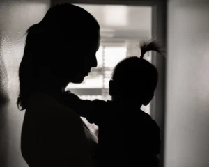 silhouette of a stressed mother taking care of her young child