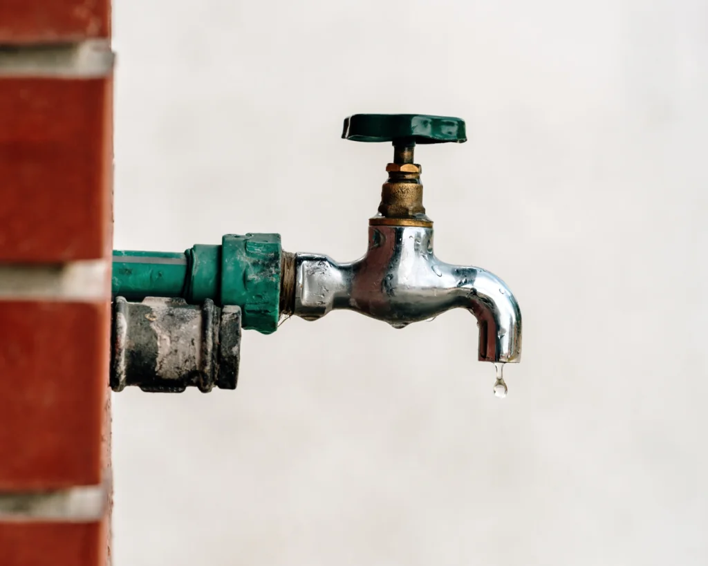 Back yard outdoor garden faucet with drop of water