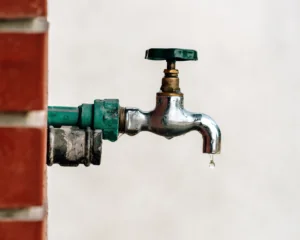 Back yard outdoor garden faucet with drop of water