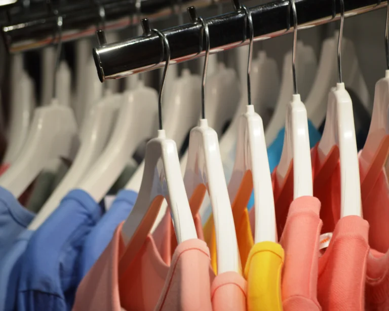 Clothes on hangers in a store. Fast fashion concept