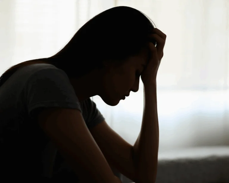Silhouette photo of a young woman feeling discomfort and pain