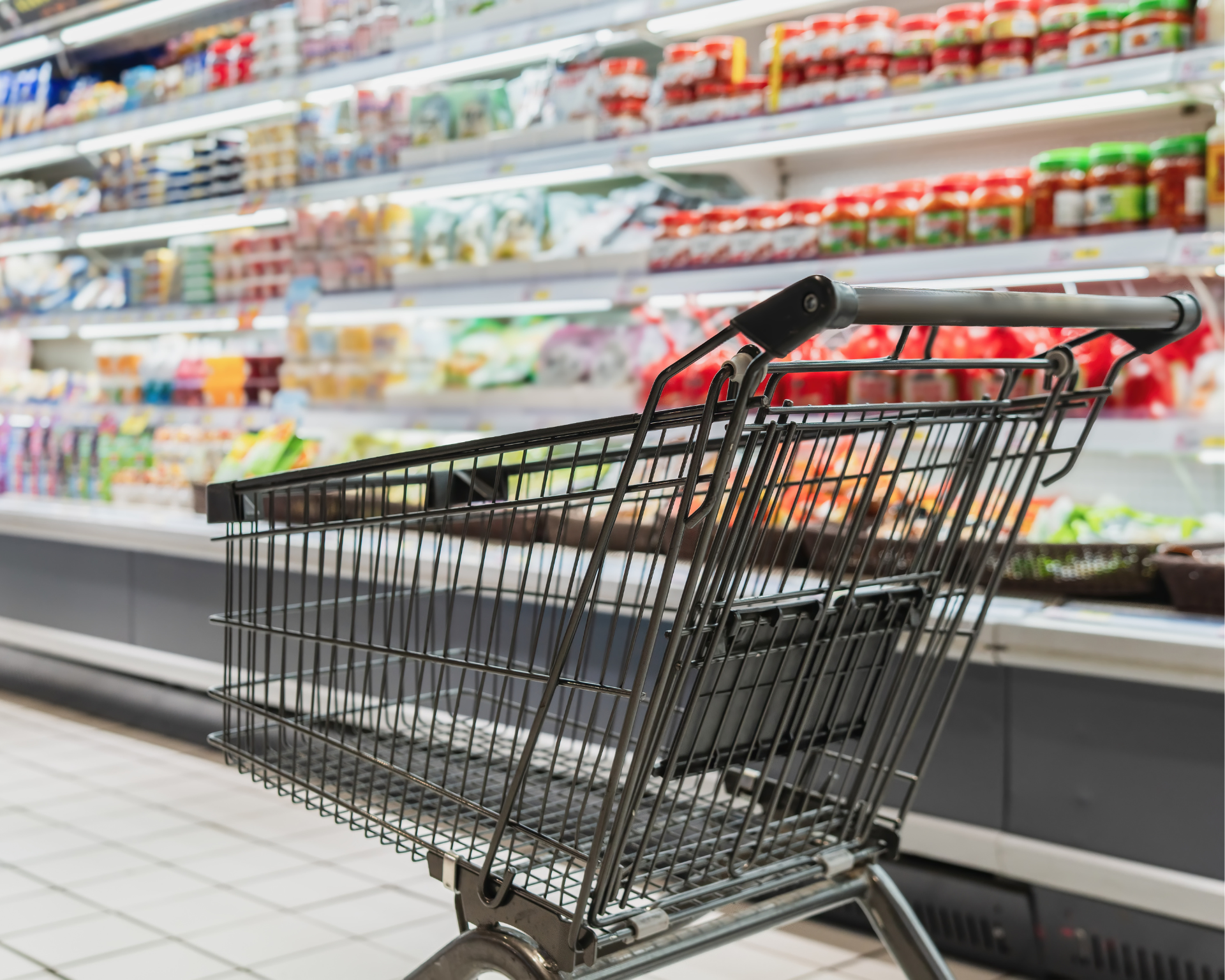 An empty shopping cart in a grocery store. Food insecurity concept