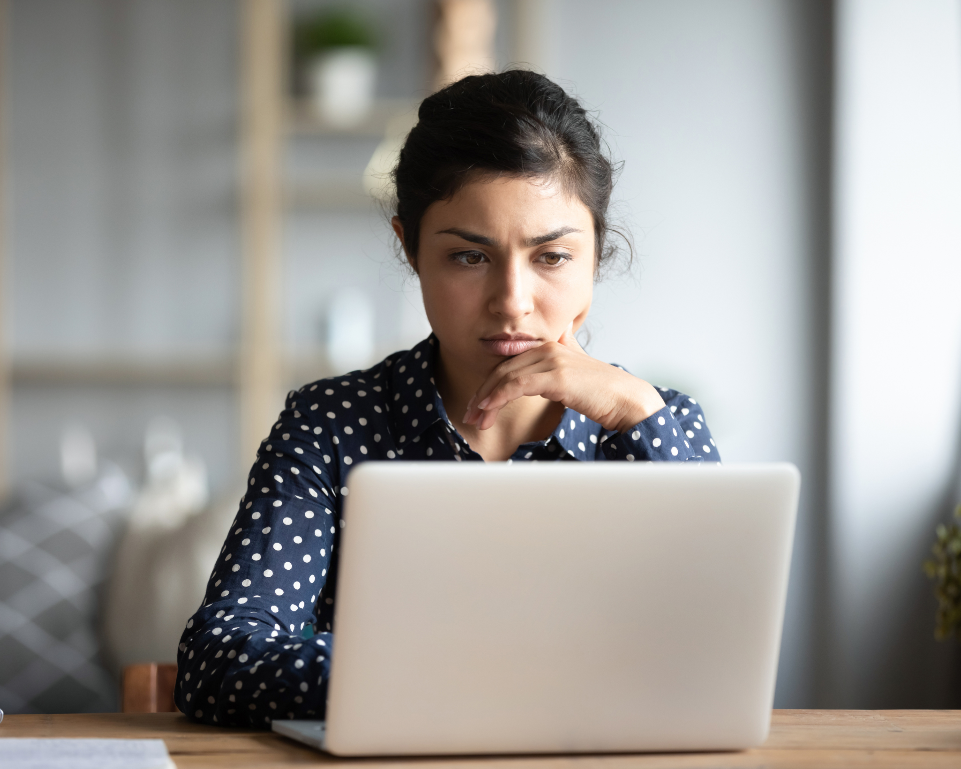 Portrait of a woman seriously looking at her laptop search. Concept for finding health advice online