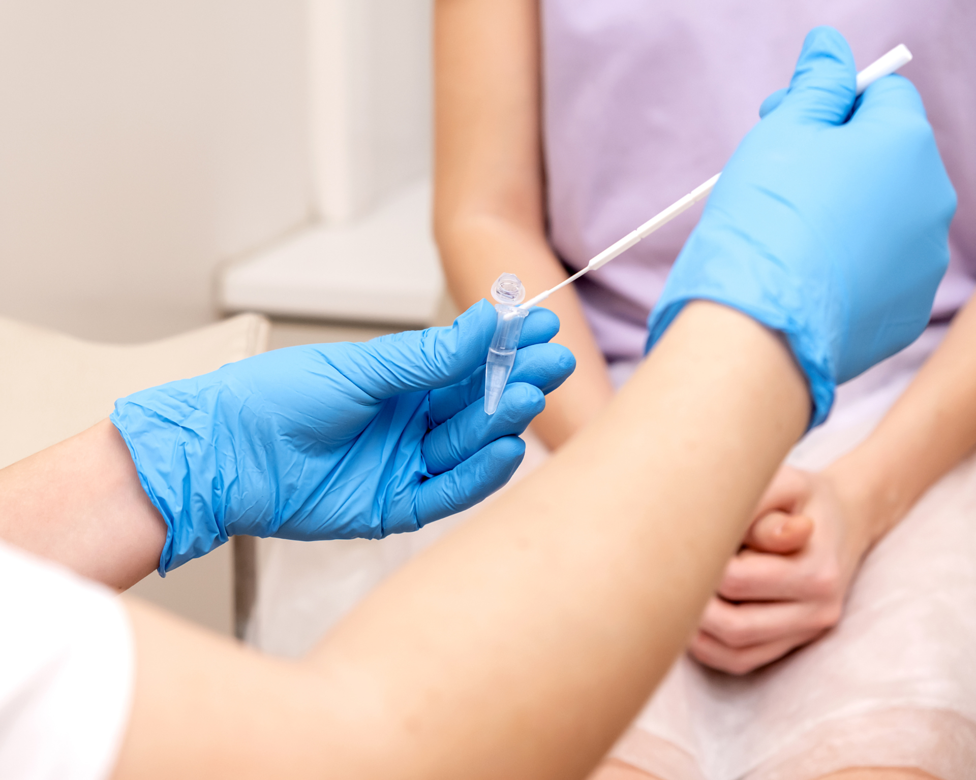 Close-up of a doctor handling a sample with a woman in the background. Sexually transmitted infection concept