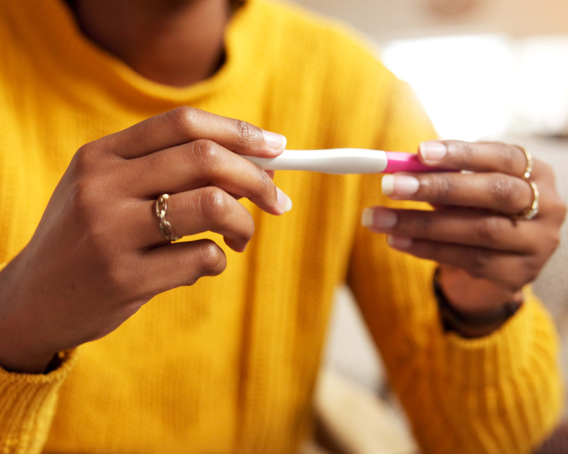 Close up of woman's hands holding pregnancy test. IVF, infertility concept