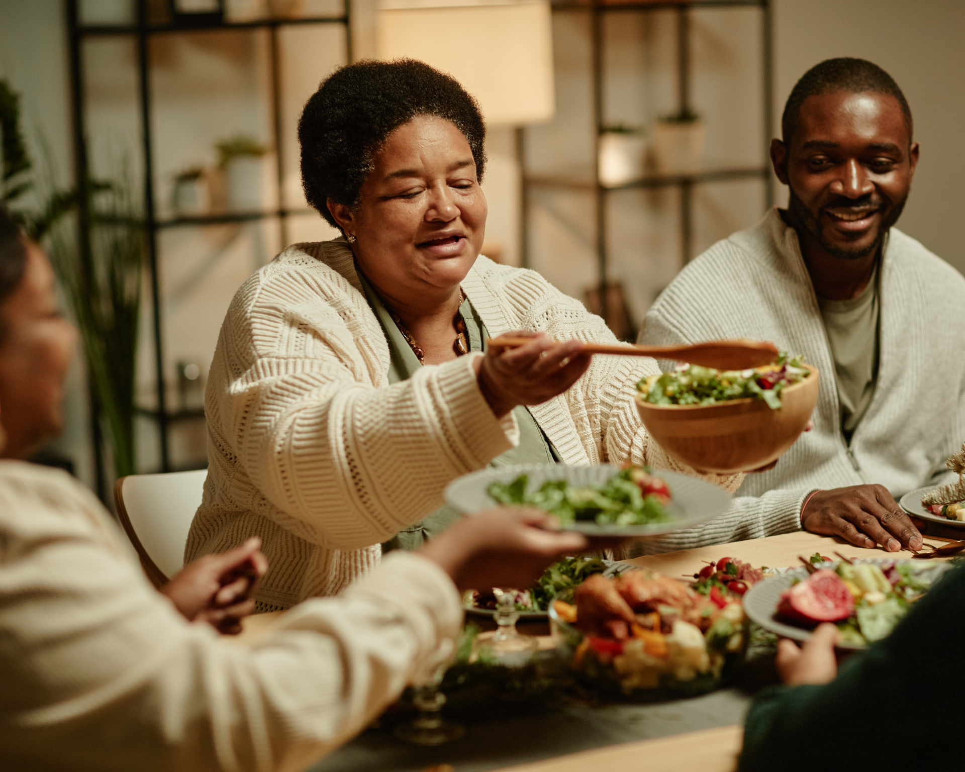 Portrait of a smiling Black family sitting down for a meal together. Soul food concept