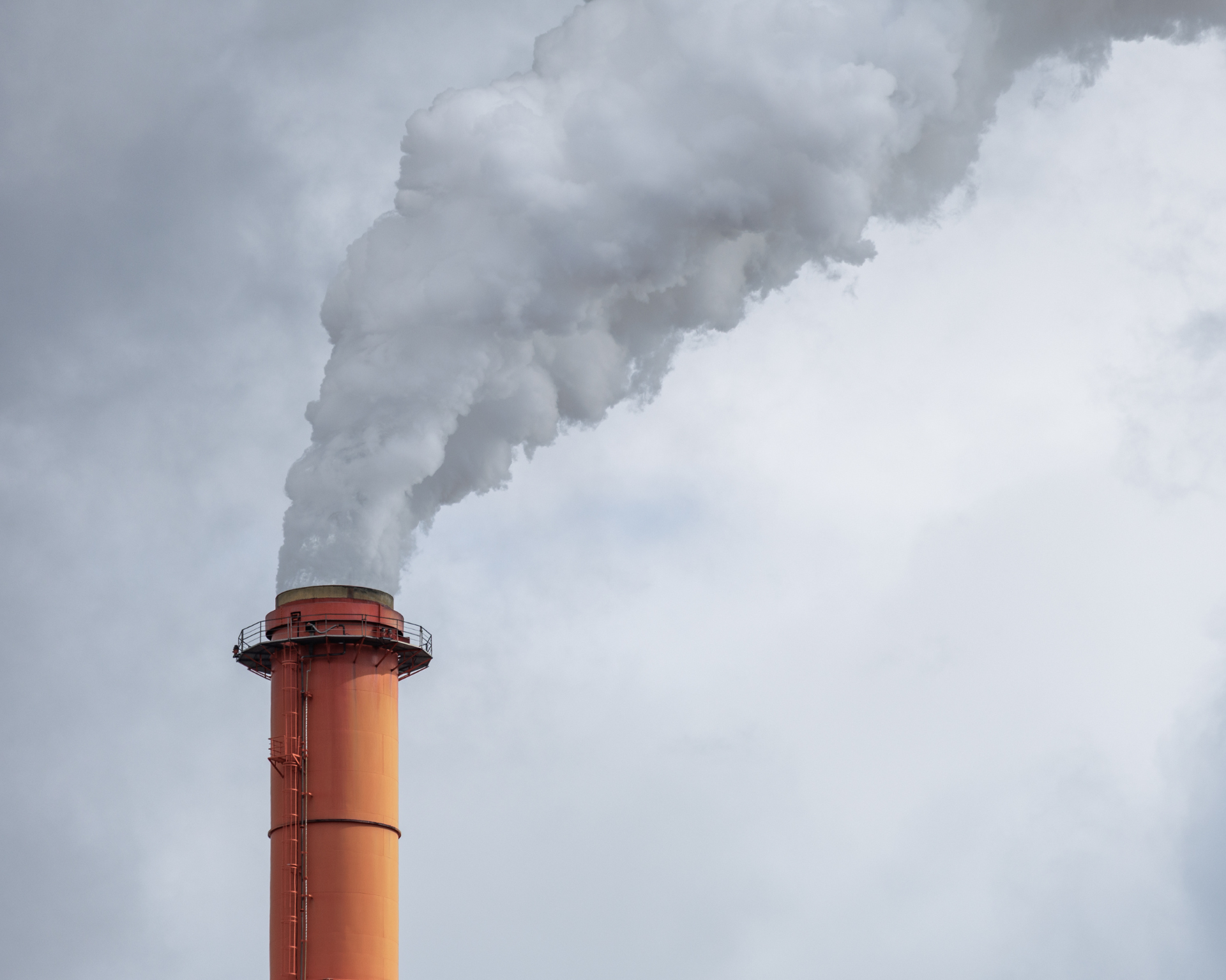 Smoke coming out of an industrial chimney stack. Air pollution concept