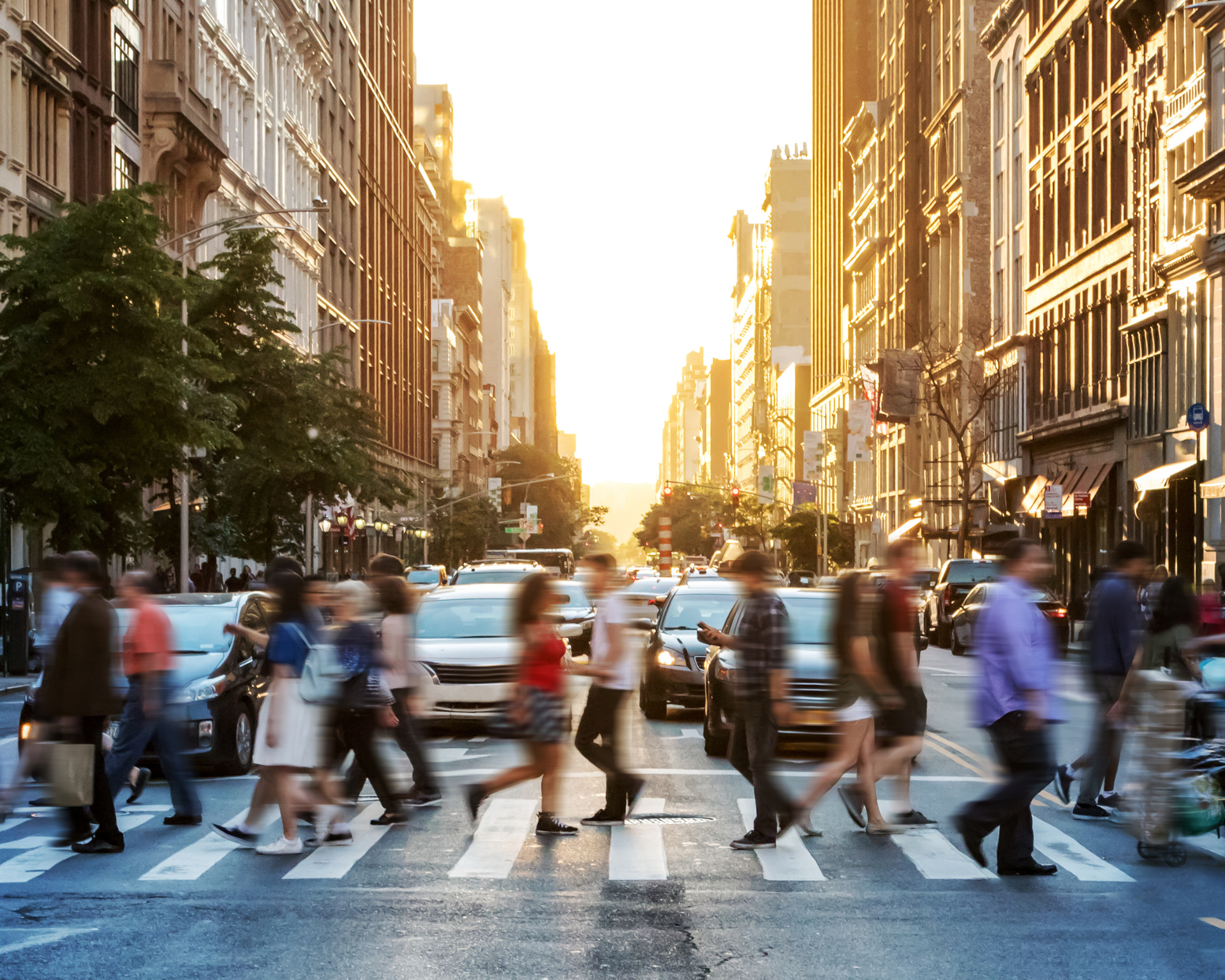 Crowds of people walking across a busy crosswalk at the intersection of 23rd Street and 5th Avenue in Manhattan New York City